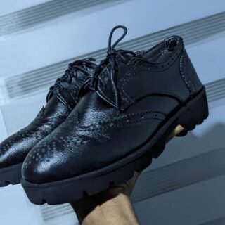 Black leather brogue-style dress shoe