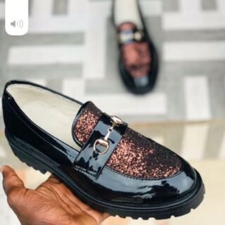 Glossy loafer with a glittery maroon upper and a metal buckle accent